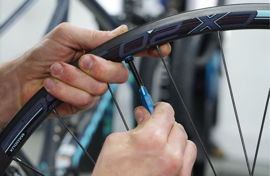 Securing a tubeless valve to wheel without the tyre attached