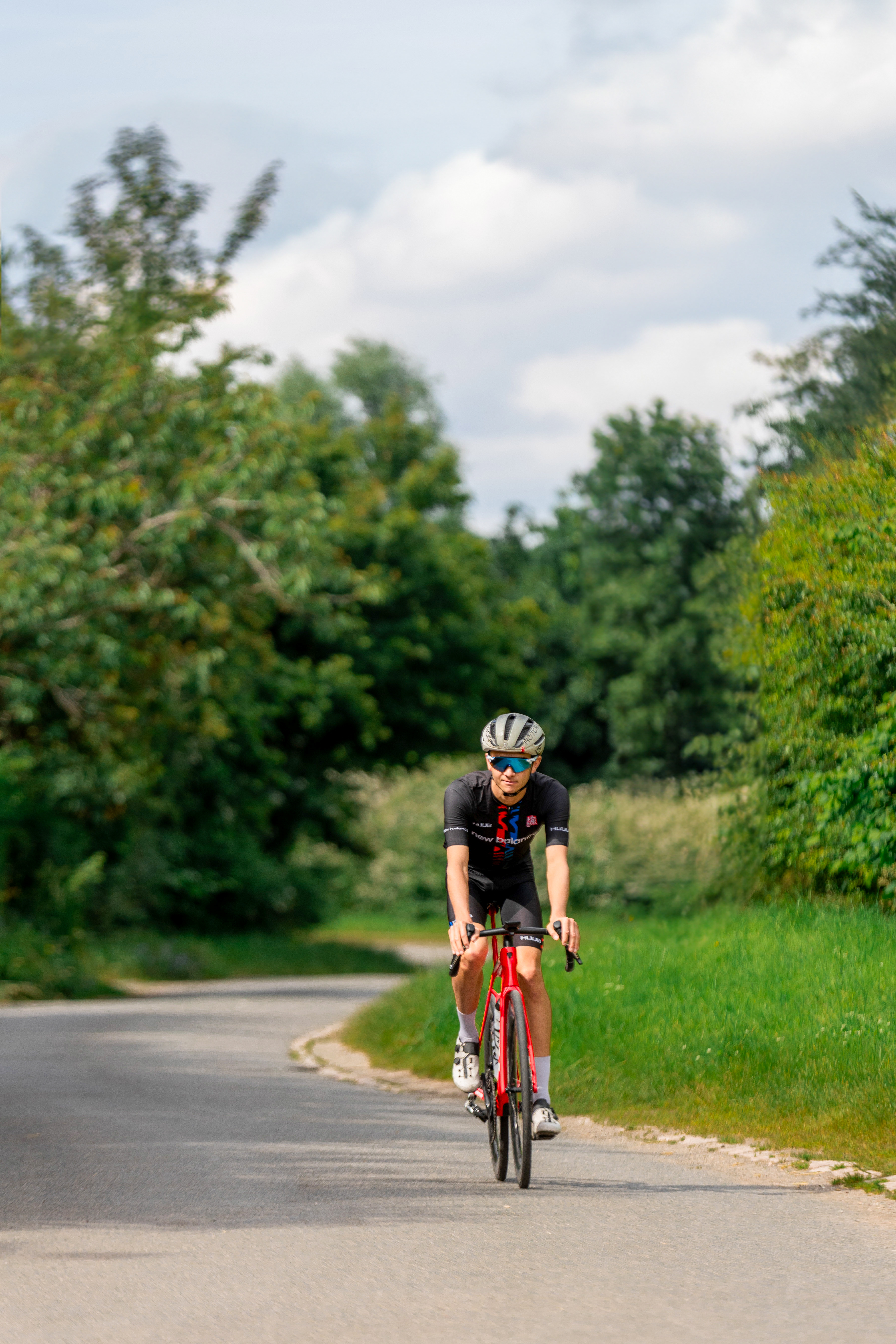 Alex Yee Triathlete Riding a Red Trek Bike
