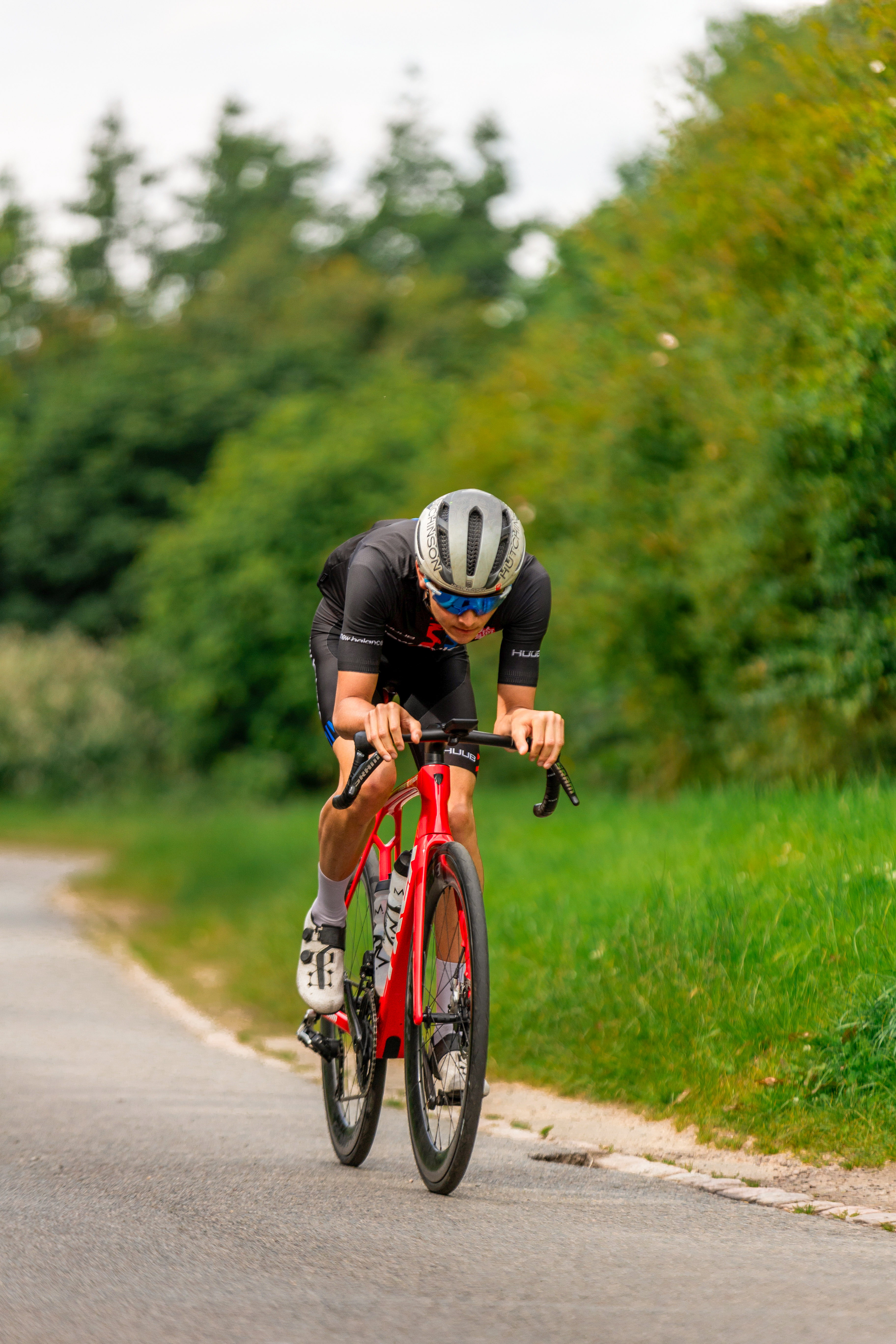 Alex Yee Triathlete Riding a Red Trek Bike