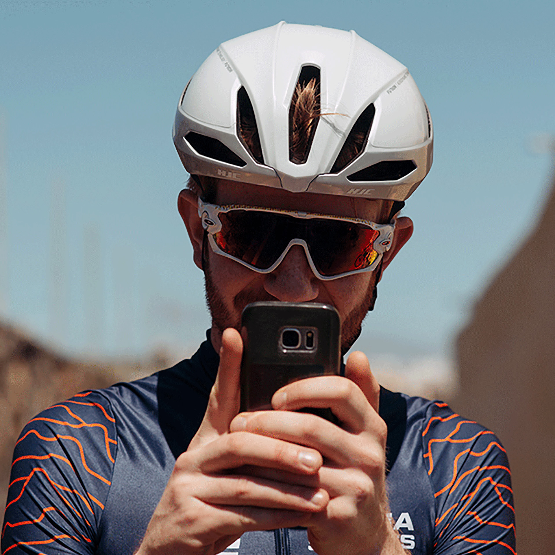 Cyclist taking a photo using a phone