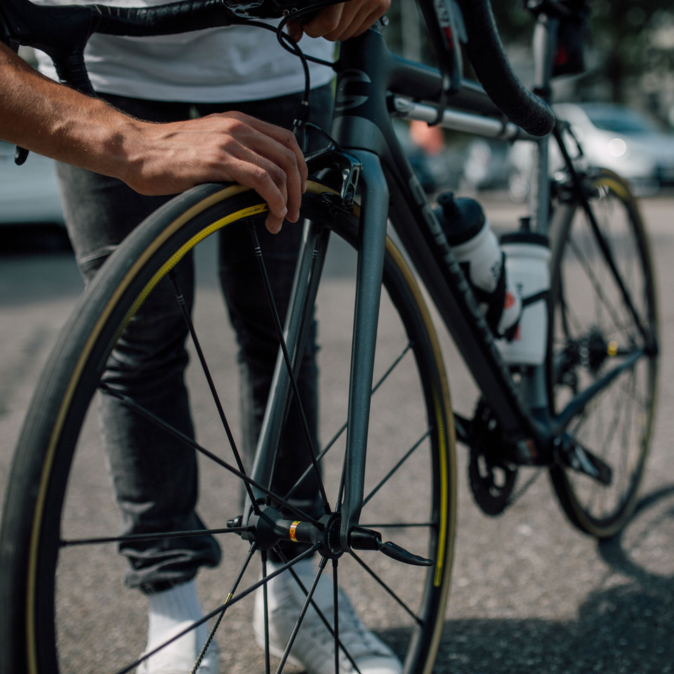 Cyclist Checking Bike Wheel