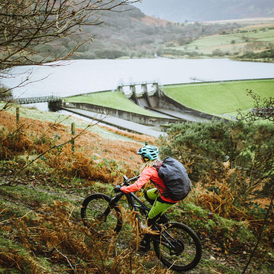 Riding Specialized Turbo Levo Mountain Bike up climb