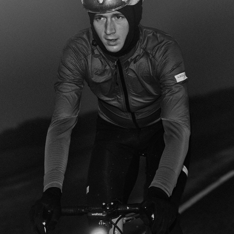 Cyclist wearing winter clothing including gloves